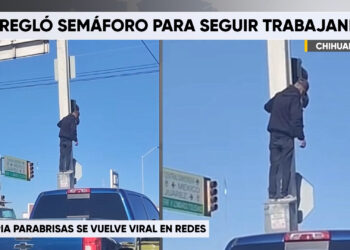 Limpia parabrisas escala semáforo para reparar falla en la intersección